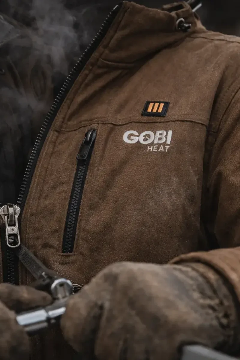 Close-up of grizzly heated work jacket zipper and reinforced stitching during cold construction work